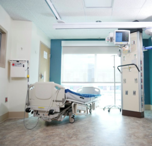 A hospital room with a bed and expensive equipment.