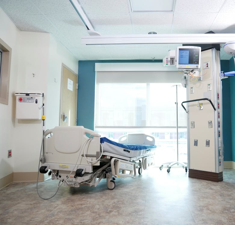 A hospital room with a bed and expensive equipment.