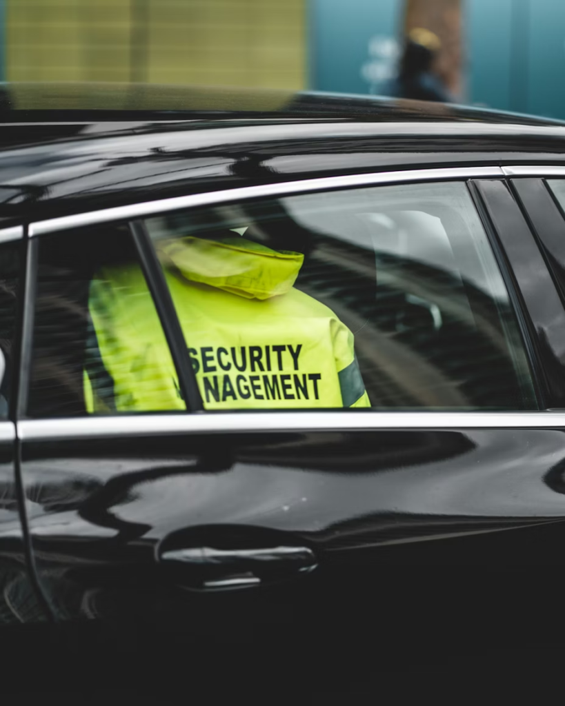 A security professional in a car.